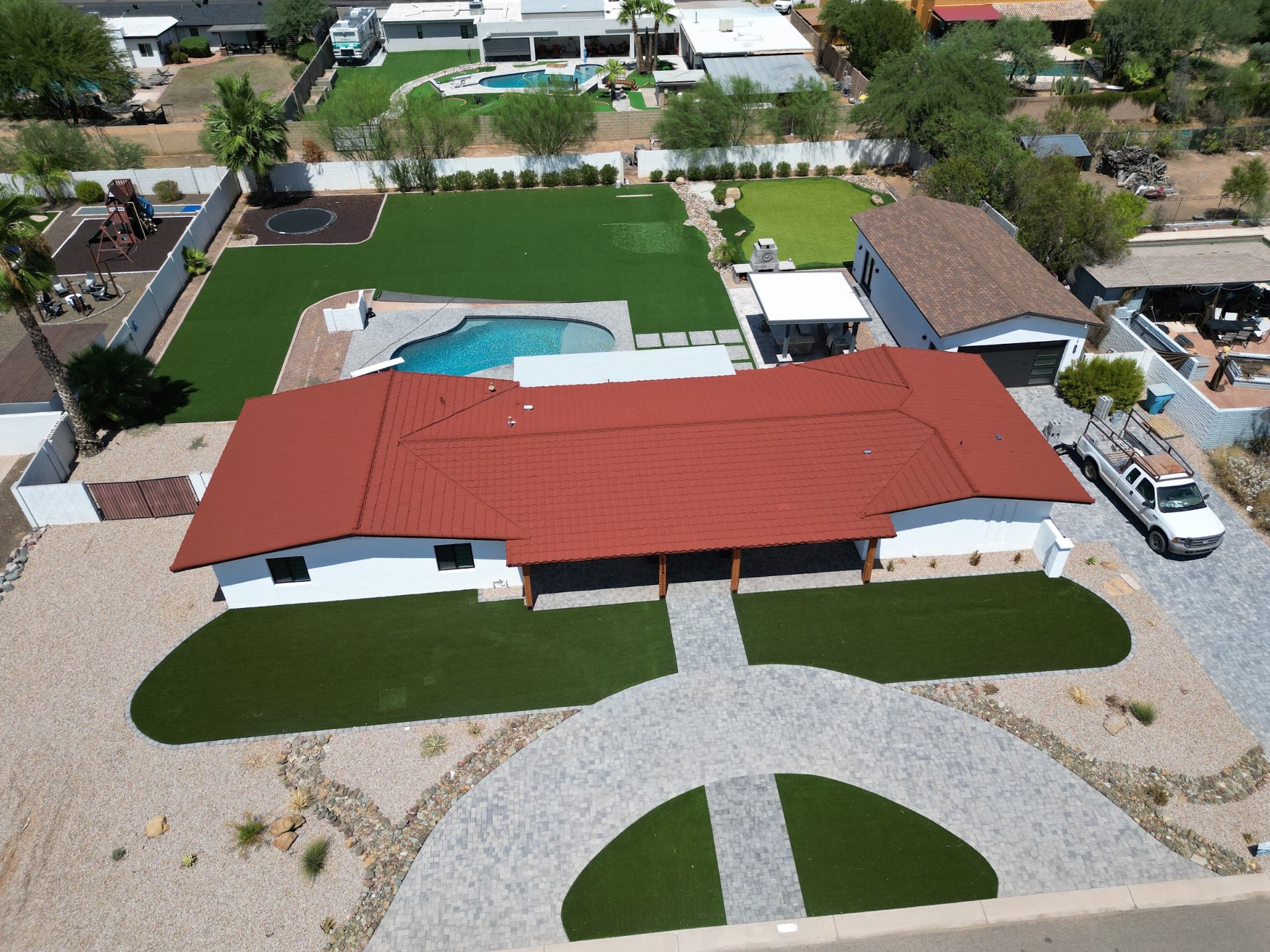 Red stone-coated steel roof on an Arizona ranch home